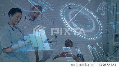 Analyzing doctor and nurse examining patient data in hospital room with holographic displays 135672123