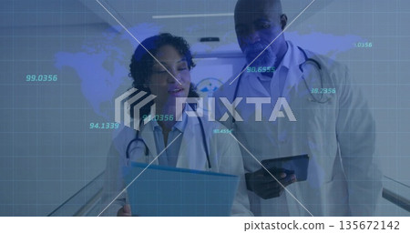 Scanning clipboard and tablet, doctors working in hospital corridor with digital overlay 135672142