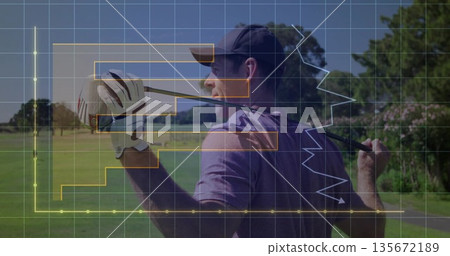 Man wearing cap and golf glove holding driver club behind shoulder on fairway, showing grid charts 135672189