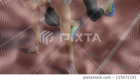 Two athletes in sportswear powering into sprint start on running track, with blocks, lane lines 135672191