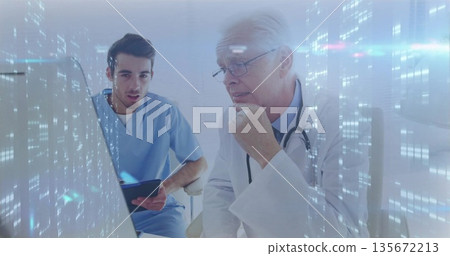 Analyzing doctors in lab coat and scrubs reviewing patient data at hospital with monitor and tablet Analyzing doctors in lab coat and scrubs reviewing patient data at hospital with monitor and tablet 135672213