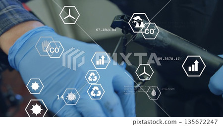 Inspecting hands in blue nitrile gloves grasping device at lab bench with digital icons and metrics Inspecting hands in blue nitrile gloves grasping device at lab bench with digital icons and metrics 135672247