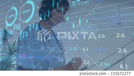 Nurse wearing scrubs and stethoscope writing on clipboard in clinic corridor, with finance overlay 135672277