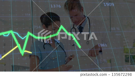 Scrub-clad nurse and lab-coat doctor examining patient data on clipboard under grid overlay in ward 135672298