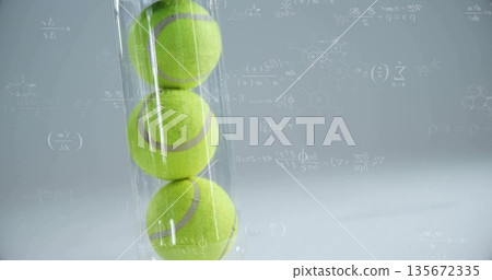 Showing transparent vertical tube holding three green tennis balls in studio, with formula overlay 135672335