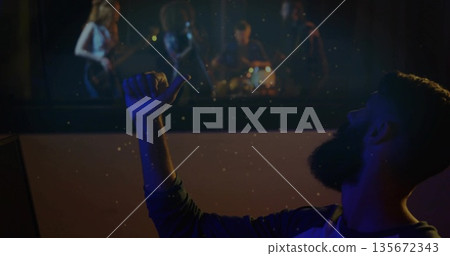 Giving thumbs up engineer monitoring band rehearsing in control room, soundproof window, copy space 135672343