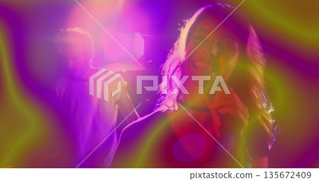 Performing female singer holding microphone on stage in music venue, with lighting rig, lens flares Performing female singer holding microphone on stage in music venue, with lighting rig, lens flares 135672409