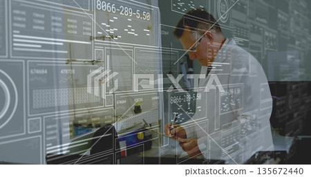 Examining scientist wearing lab coat, goggles in lab, holding electronic part and precision tool 135672440