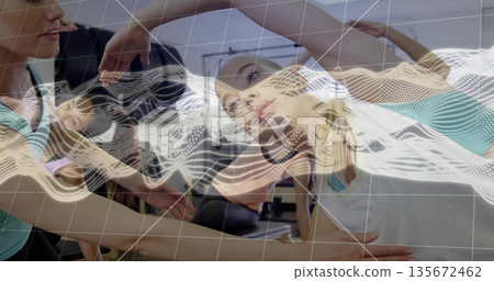 Synchronized women in sportswear bending sideways in gym studio, with machines, digital grid Synchronized women in sportswear bending sideways in gym studio, with machines, digital grid 135672462