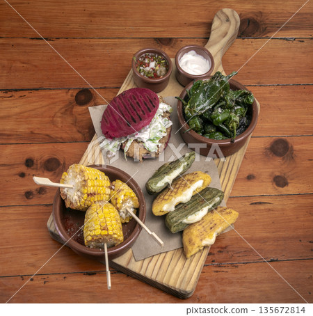 mixed colombian and venezuelan snack food platter on wooden restaurant table mixed colombian and venezuelan snack food platter on wooden restaurant table 135672814