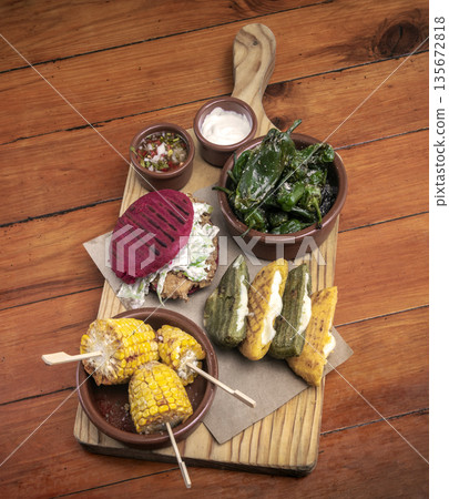mixed colombian and venezuelan snack food platter on wooden restaurant table mixed colombian and venezuelan snack food platter on wooden restaurant table 135672818