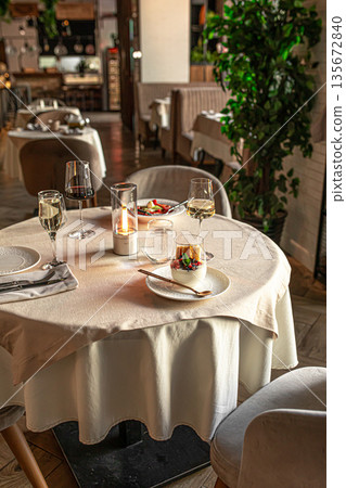 Elegant restaurant table with dessert and wine 135672840