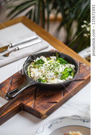 Skillet eggs with broccoli feta and herbs Skillet eggs with broccoli feta and herbs 135672891