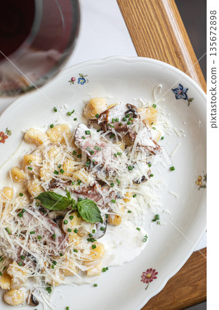 Gnocchi with creamy sauce and sliced meat Gnocchi with creamy sauce and sliced meat 135672898