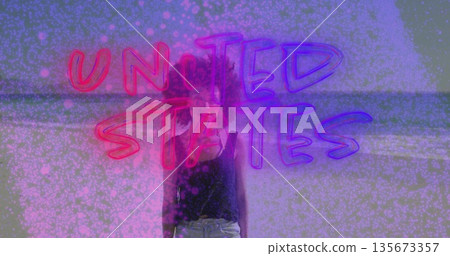 Standing woman wearing black top on beach, with neon-text reading UNITED STATES, pink dots overlay 135673357