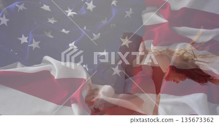 Couple wearing casual attire executing dance lift in studio, with American flag overlay Couple wearing casual attire executing dance lift in studio, with American flag overlay 135673362