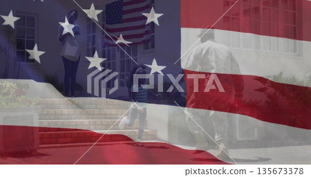 Approaching uniformed service member carrying duffel bag at porch steps, American flag overlay Approaching uniformed service member carrying duffel bag at porch steps, American flag overlay 135673378