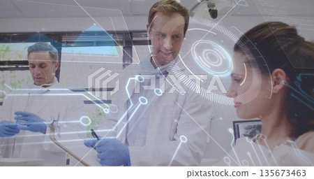 Examining gloved scientist in lab coat with clipboard pointing at holographic display on lab bench Examining gloved scientist in lab coat with clipboard pointing at holographic display on lab bench 135673463