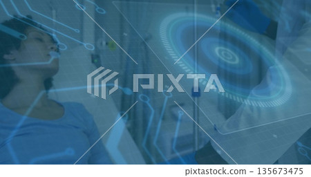 Monitoring doctor wearing lab coat adjusting IV line in ward with digital interface, copy space Monitoring doctor wearing lab coat adjusting IV line in ward with digital interface, copy space 135673475