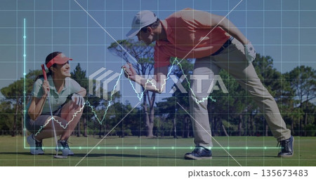 Aligning couple in golf attire lining putt on putting green, with digital grid and line chart 135673483