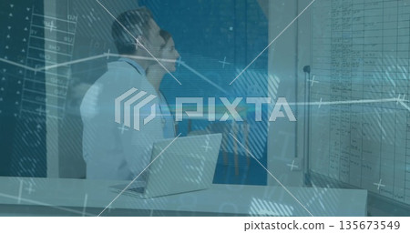 Scanning data, two medics in lab coats using laptop and board in lab, with digital overlay Scanning data, two medics in lab coats using laptop and board in lab, with digital overlay 135673549