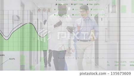 Walking medical team discussing data in hospital corridor, with tablet, stethoscope, digital graphs 135673609