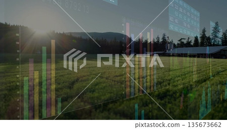 Overlaying bar charts and data panels over crop field, barn, evergreen trees, hills under low sun 135673662