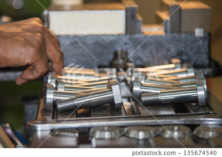 Metal Screw Parts Production in Workshop with Lathe Machine Operator 135674540