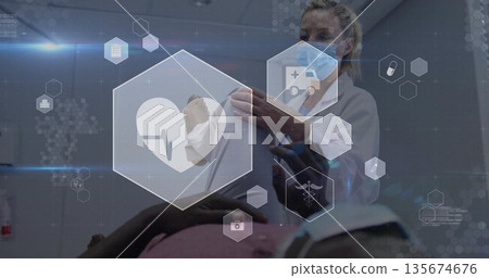 Assessing doctor wearing mask examining patient on exam table in clinical room, with AR icons Assessing doctor wearing mask examining patient on exam table in clinical room, with AR icons 135674676