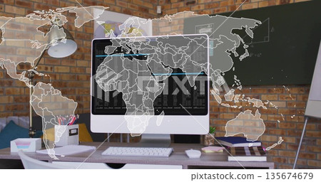 Displaying monitor showing code with world map overlay on desk in home office, with chalkboard Displaying monitor showing code with world map overlay on desk in home office, with chalkboard 135674679