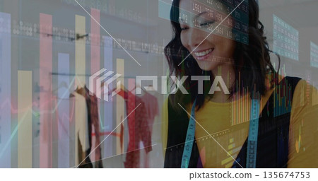 Smiling mid-adult Asian fashion designer wearing tape measure in studio, chart overlay, copy space Smiling mid-adult Asian fashion designer wearing tape measure in studio, chart overlay, copy space 135674753