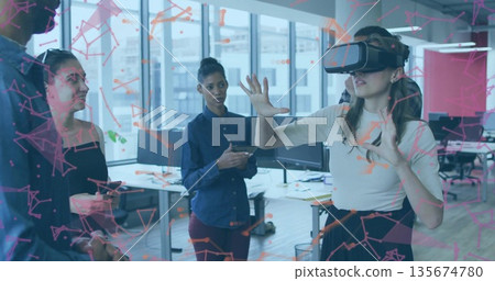 Demonstrating colleague wearing short-sleeve top gesturing at office, with VR headset, copy space Demonstrating colleague wearing short-sleeve top gesturing at office, with VR headset, copy space 135674780