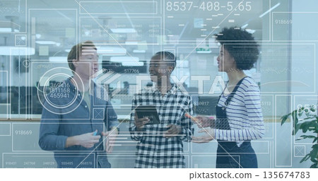 Colleagues discussing data graphics on smartphone and tablet in office, holding coffee mugs Colleagues discussing data graphics on smartphone and tablet in office, holding coffee mugs 135674783