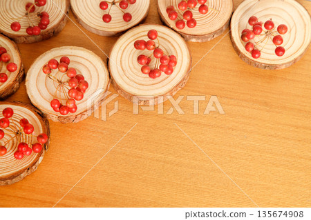 Red berries of Sankirai served with slices of wood 135674908