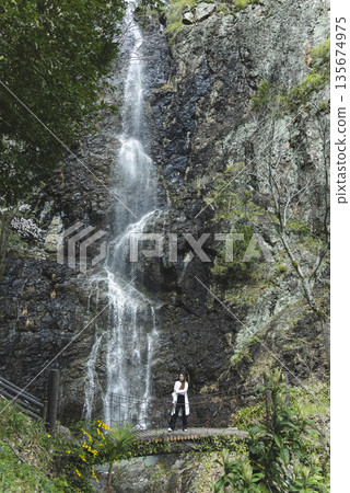 A person who takes a waterfall A person who takes a waterfall 135674975