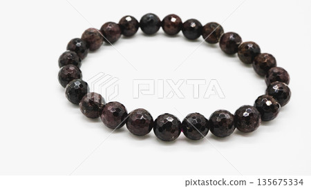 Garnet natural stone bracelet macro photography white background Garnet natural stone bracelet macro photography white background 135675334