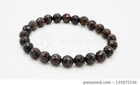 Garnet natural stone bracelet macro photography white background Garnet natural stone bracelet macro photography white background 135675336