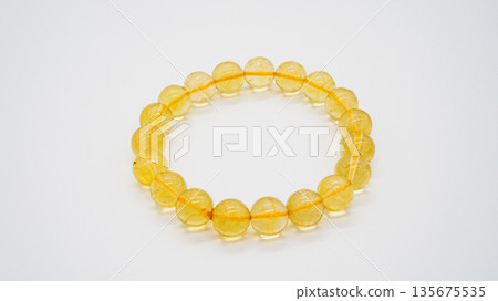 Citrine natural stone bracelet macro photography white background Citrine natural stone bracelet macro photography white background 135675535