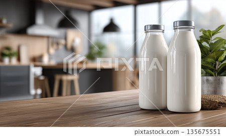 Two glass bottles of fresh milk on wooden table in modern kitchen interior Two glass bottles of fresh milk on wooden table in modern kitchen interior 135675551