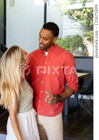 Celebrating at home, couple holding champagne glasses and smiling together 135675809