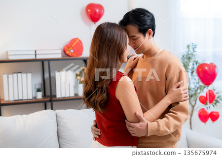 Romantic asian couple standing with head touch, feeling love and tenderness at home. Romantic asian couple standing with head touch, feeling love and tenderness at home. 135675974