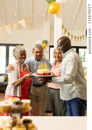 Celebrating 60th birthday with cake and balloons, family sharing joyful moments together Celebrating 60th birthday with cake and balloons, family sharing joyful moments together 135676017