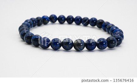 Lapis lazuli bracelet on white background, macro photography Lapis lazuli bracelet on white background, macro photography 135676416
