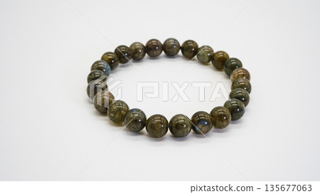 Labradorite natural stone bracelet macro photography white background Labradorite natural stone bracelet macro photography white background 135677063