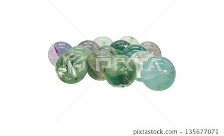 Rainbow fluorite natural stone beads macro photography white background 135677071