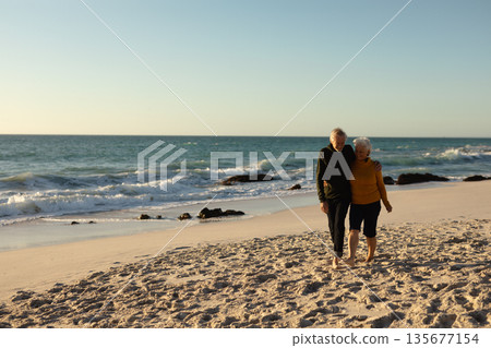 Senior couple walking on the beach, near ocean 135677154