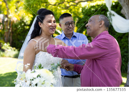 Greeting guests, bride in white dress smiling at outdoor senior wedding ceremony Greeting guests, bride in white dress smiling at outdoor senior wedding ceremony 135677335