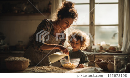 Mother and child cooking together at home kitchen pouring milk into bowl with cereal ingredients 135678198
