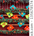 Vertical photo of a wooden Christmas decorative wall with fir branches, garlands, and gift boxes. Festive background for banners, social media, and holiday advertising. 135678574