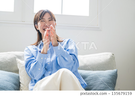 Woman relaxing on the sofa Woman relaxing on the sofa 135679159